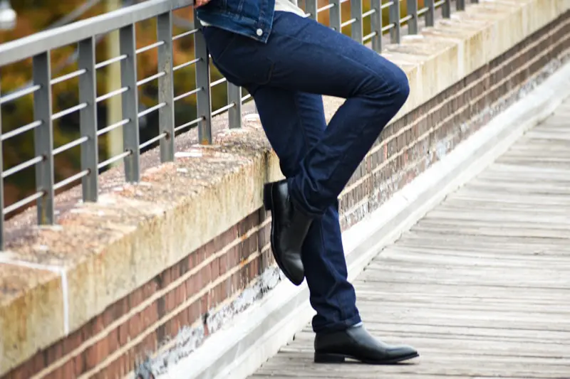 Man Wearing Dark Washed Denim Jeans Paired with Boots