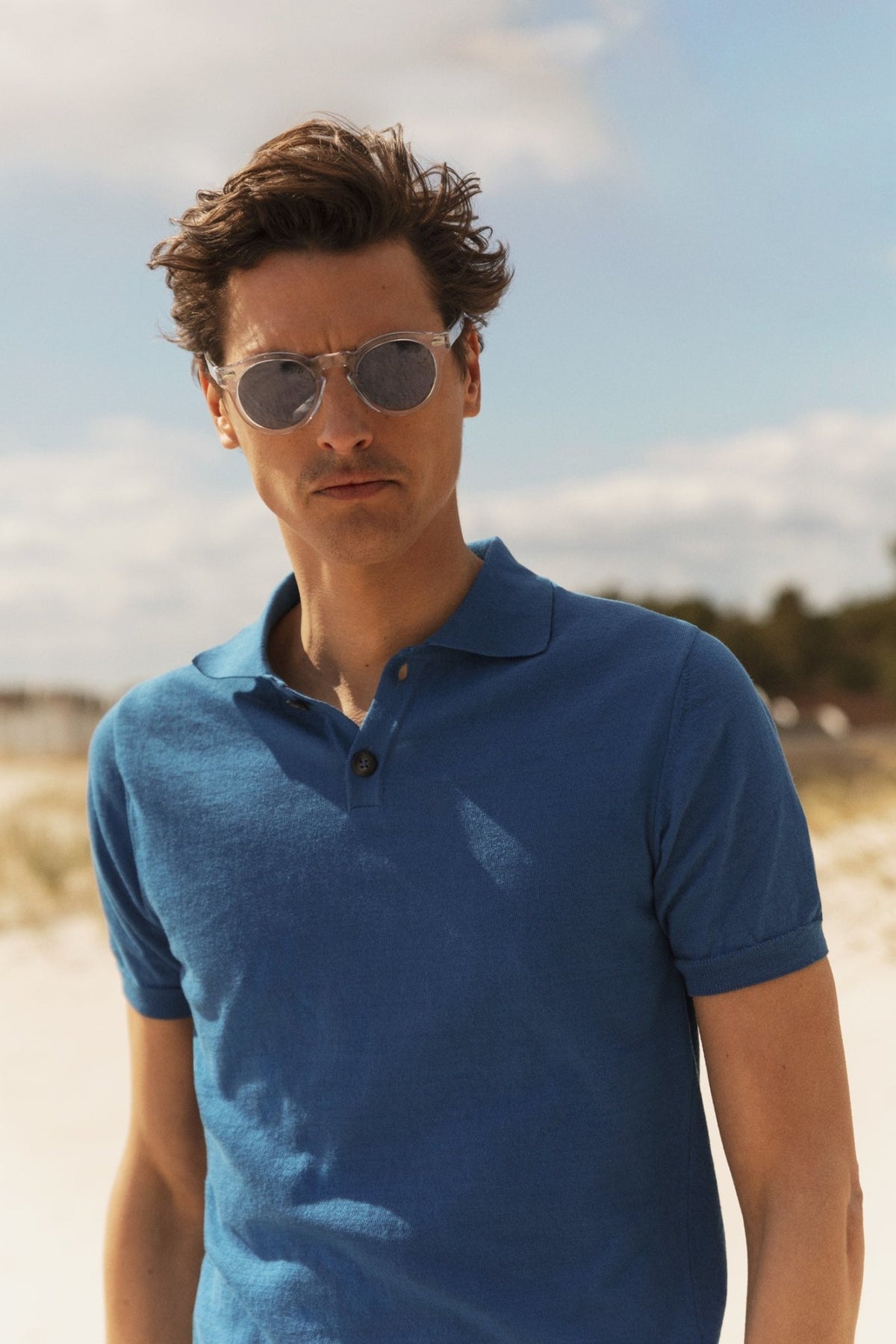 Man Wearing The Resort Co Blue Polo and Sunglasses